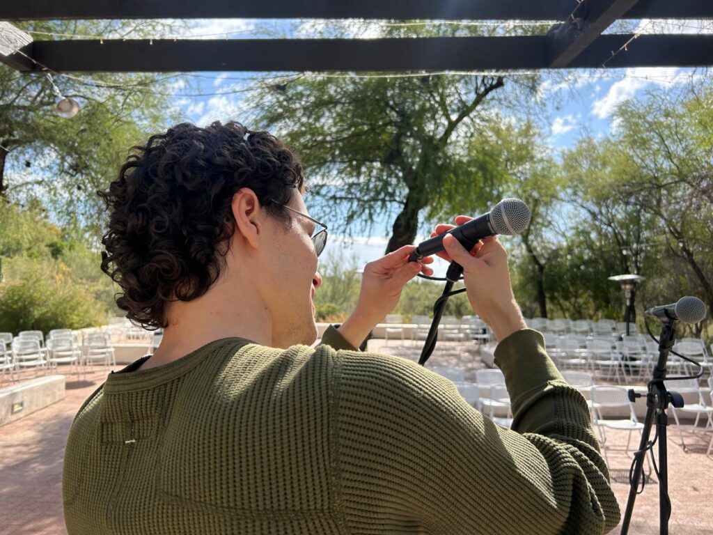 Dante setting up microphones for a concert